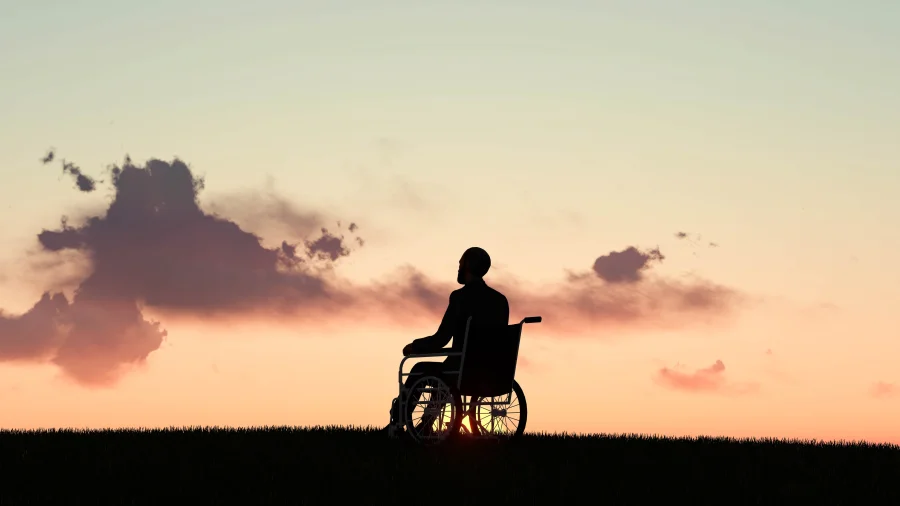 Image of a disabled man at sunset