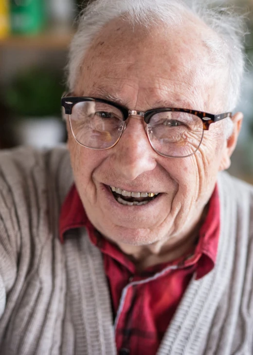 Elderly man with glasses taking a selfie