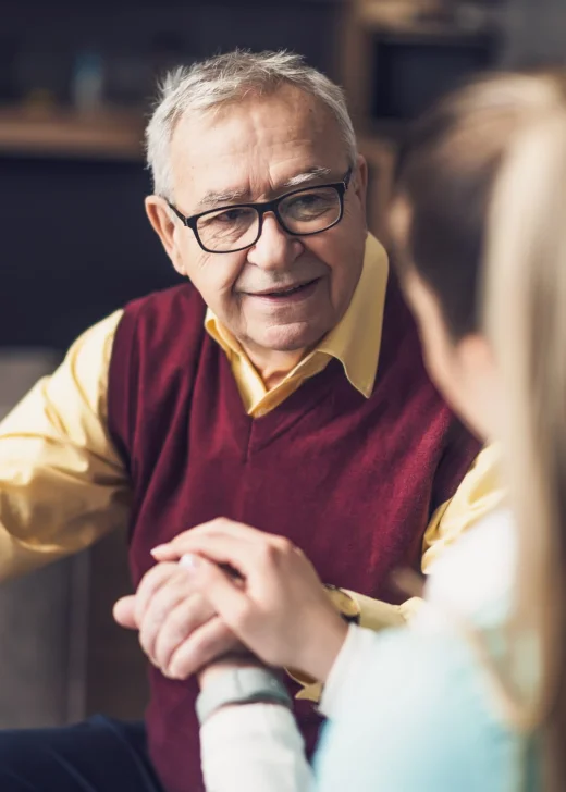 Home nurse visiting senior man to check his health. Professional caregiver is assisting old man at his home.