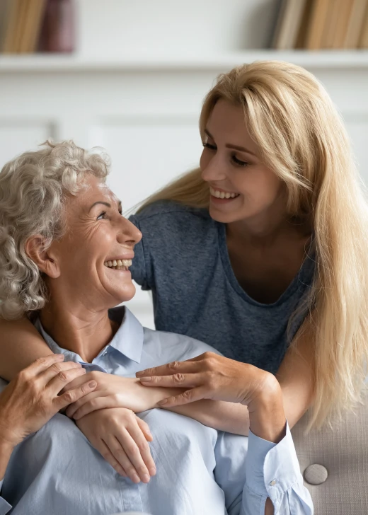 Young home care nurse smiling at a female home care patient