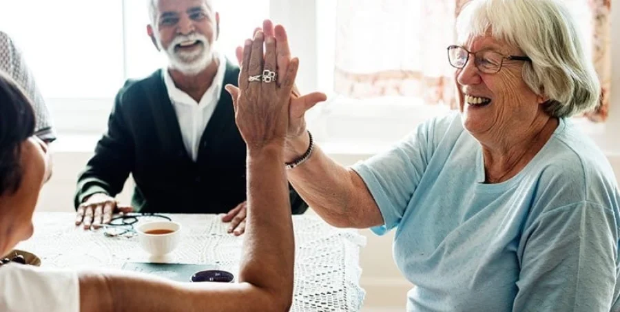 A nurse high-fiving a patient at home